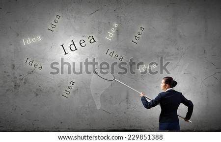 Young businesswoman catching word idea with hoop