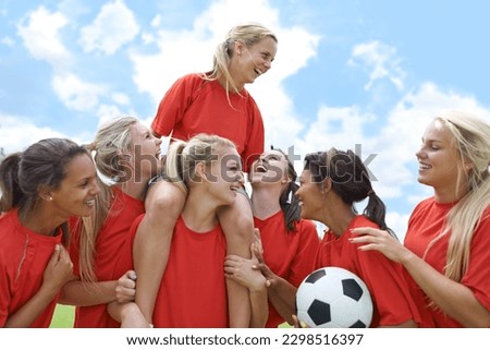 Sports, success and women soccer team winner celebrating victory, achievement or match goal on field. Football, champion and girl group lifting captain in celebration, competition or training triumph Royalty-Free Stock Photo #2298516397