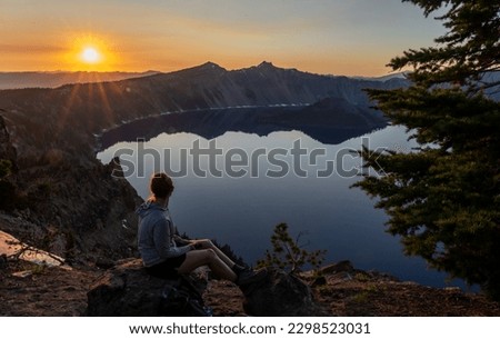 Woman Sits To Watch Sunset Over Crater Lake In Summer from Garfield Peak Trail