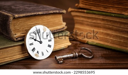 Old vintage watch and key with books, escape room game banner. Time background. Royalty-Free Stock Photo #2298553695