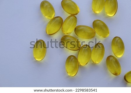 vitamin D in softgel capsules on white background