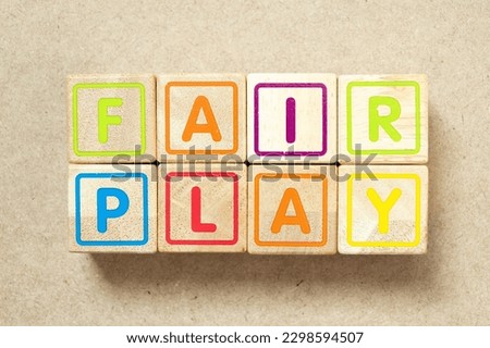 Wooden alphabet letter block in word fair play on wood background
