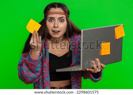 Exhausted freelancer woman with pasted sticker notes use laptop computer having concentration problem creative crisis. Nervous girl confused by big routine work loading on green chroma key background