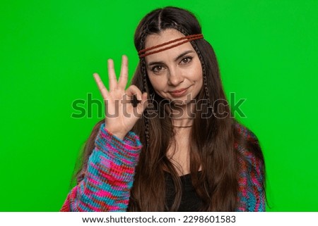 Okay. Young happy hippie woman looking approvingly at camera showing ok gesture, like sign positive, approve something good. Pretty girl isolated alone on studio chroma key background, green screen
