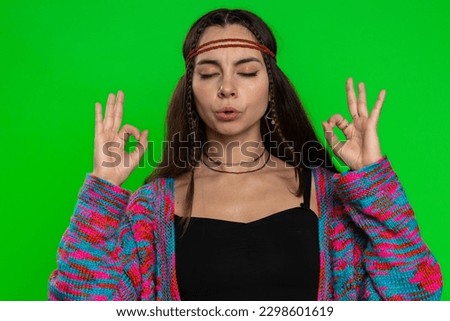 Keep calm down, relax, inner balance. Young woman breathes deeply with mudra gesture, eyes closed, meditating with concentrated thoughts, peaceful mind. Girl isolated on green chroma key background