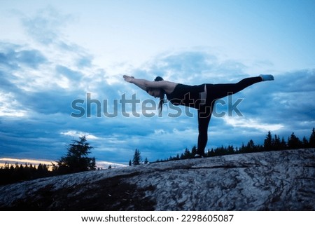 Young Woman Practicing Yoga In The Nature On The Sunset In A Rocky Area. Meditating Outdoor
