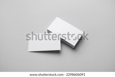 Photo of blank business cards on gray paper background. Template for ID.