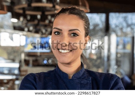 Young north african chef woman smiling on camera at the restaurant - Focus on face Royalty-Free Stock Photo #2298617827