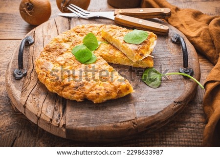 Spanish omelet (Tortilla de patatas) with potatoes and onion, typical Spanish cuisine.  Royalty-Free Stock Photo #2298633987