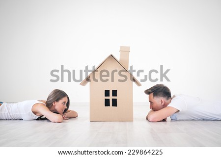 Daydreaming young couple at home Royalty-Free Stock Photo #229864225