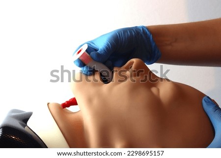 Oropharyngeal airway Beeing inserted by a health care professional wearing gloves Royalty-Free Stock Photo #2298695157