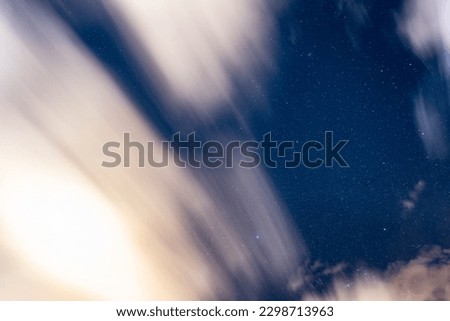 Stars with clouds over the mountains at night. Country side.