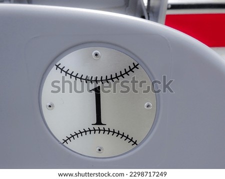 Gray stadium seat number one, 1, in the shape of a baseball or softball, graphics concept
