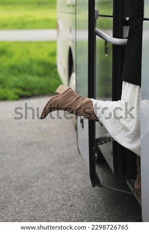 girl enters the bus, tourist bus, beautiful leg, Cossack boots, cowboy boots, tourism, bus ride