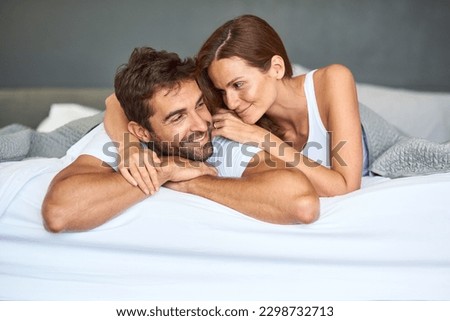 I want to love you forever and a day. a happy young couple relaxing in bed together at home. Royalty-Free Stock Photo #2298732713