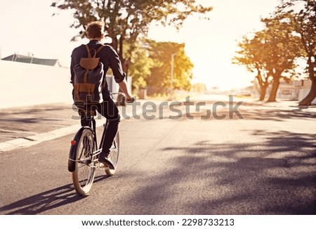 Bicycle, transport and back of man in road with lens flare for exercise, commute and cycling in morning. Travel, city and male cyclist on bike for eco friendly traveling, carbon footprint and journey Royalty-Free Stock Photo #2298733213