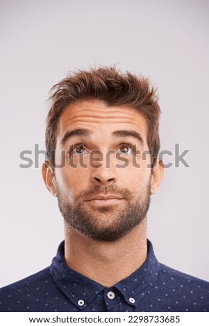 Thinking, looking up and man in studio with solution, ideas and relax with eyes and mockup. Isolated, gray background and male model face think and distracted with planning with decision alone Royalty-Free Stock Photo #2298733685