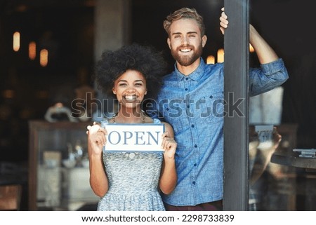 Coffee shop, open and couple portrait as small business owner or team in partnership with pride. Smile of a man and woman with signage, diversity and welcome sign as waiter and barista of restaurant
