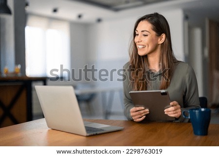 Young confident businesswoman having video conference meeting on laptop computer, presenting her ideas to the team. Home office concept