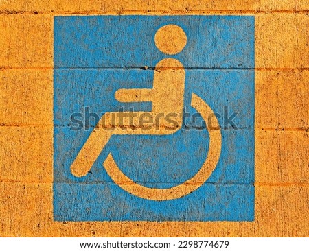 Wheelchair pictogram painted on sidewalk