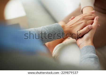 Close-up of psychiatrist hands together holding palm of her patient Royalty-Free Stock Photo #229879537