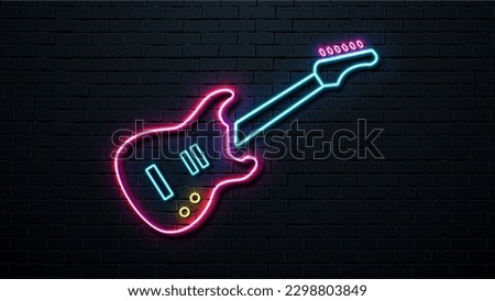 Neon guitar on the background of a brick wall. Retro signboard.