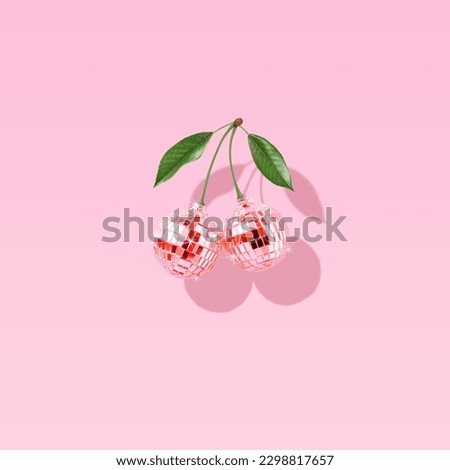 Modern retro composition made of decorative disco balls like cherries on a pastel pink background. The concept of minimal entertainment. Flat lay. Contemporary style. Creative art, minimal aesthetics. Royalty-Free Stock Photo #2298817657