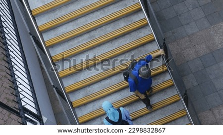 This is the random picture of people walking up and down a stair.