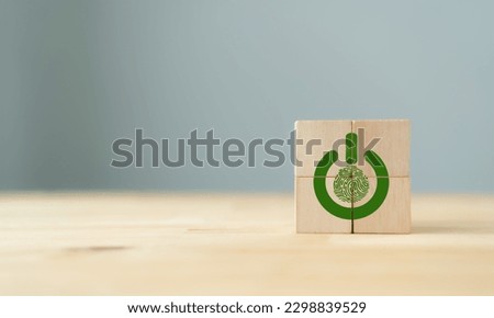 ECO solutions, Climate action concept. Actions to protect, better manage and restore nature to reduce greenhouse gas emissions. Green power button and fingerprint on wooden cube block and copy space. Royalty-Free Stock Photo #2298839529