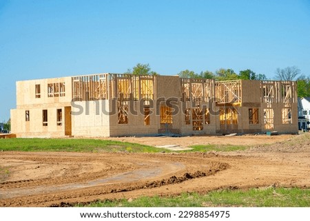 new apartment building under construction on sunny day on blue sky background wall window framework