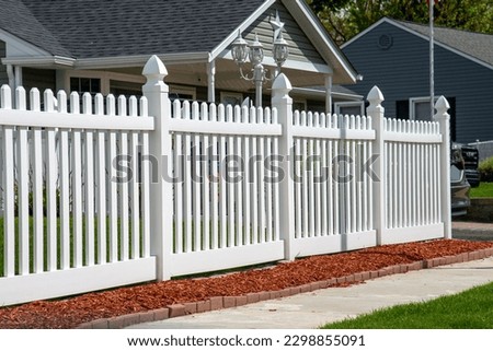 white vinyl fence in residential neighborhood home nature plastic property backyard Royalty-Free Stock Photo #2298855091