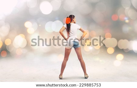 Rear view of young girl in denim shorts