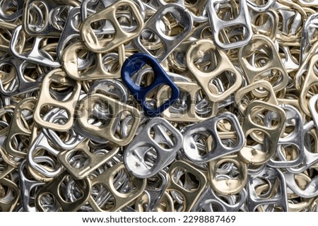 Pull-tops of silver aluminum cans collected

