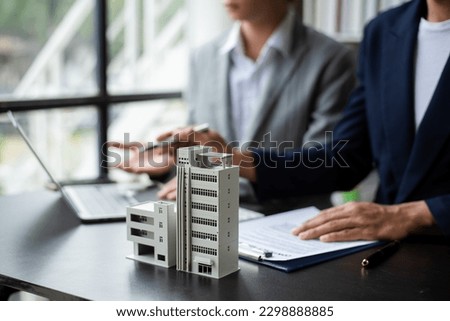 Salesman Hands On House Model , Small Toy House Small Mortgage Property insurance and concepts real estat in office Royalty-Free Stock Photo #2298888885