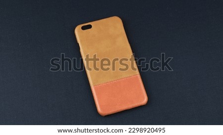High angle view of multicolored leather mobile phone cases. Isolated on black background, copy space objects. Product catalogue for online selling.