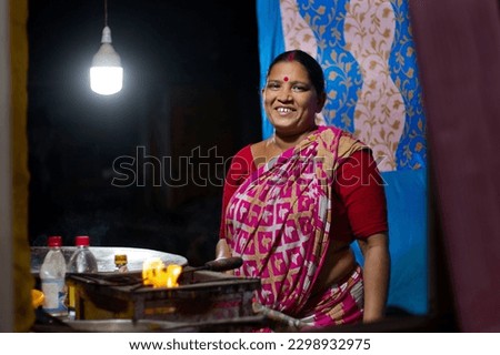 Smiling Rural indian woman standing in her shop Royalty-Free Stock Photo #2298932975