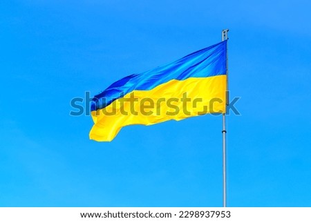 Close-up of the Ukrainian flag flying high in the sky, carried by the wind. Patriotic designs, historical or political projects related background.