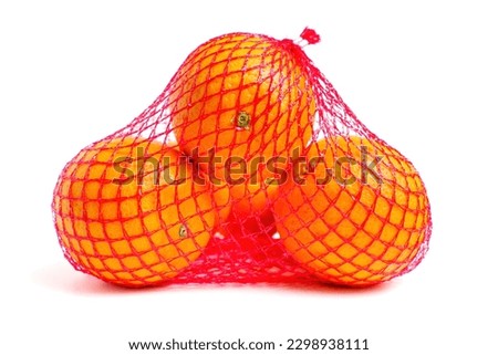 Close-up of a red mash bag with fresh and juice oranges isolated on white background.