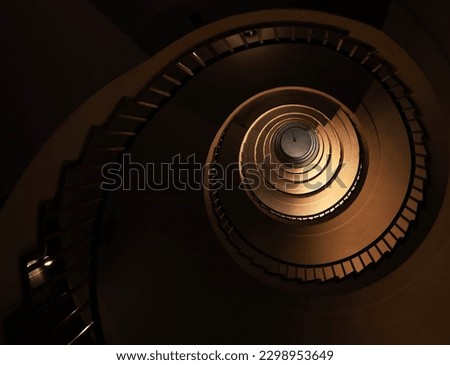 Spiral staircase in a tall multi-floor house, in the form of a "golden ratio", architecture, concert Royalty-Free Stock Photo #2298953649