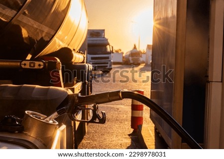 Filling the fuel tank of a truck at a gas station. Royalty-Free Stock Photo #2298978031