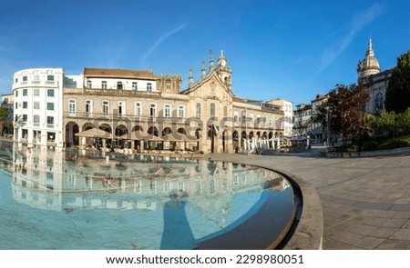sunrise view of Praca da Republica in the historical center of Braga, Portugal with reflection in fountain without logos