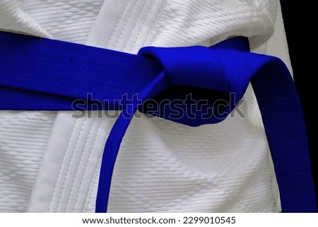 Close-up on a blue belt tied around a kimono. Royalty-Free Stock Photo #2299010545