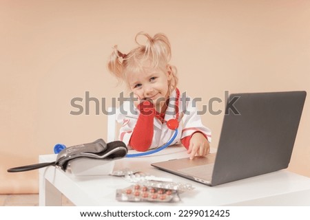 Girl doctor near the laptop looks at the camera and listens carefully
