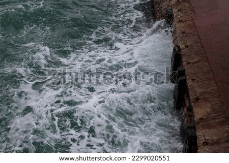 Ocean, seascape with wavy, bubbling, windy, blue, turquoise, very cold in winter. dark endless sea, rainy day. pessimistic, lonely, emotional, cold and gloomy weather, sea waves hitting big ship.