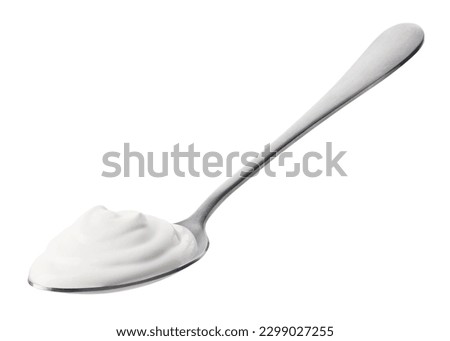 Silver spoon of fresh greek yogurt isolated on white background