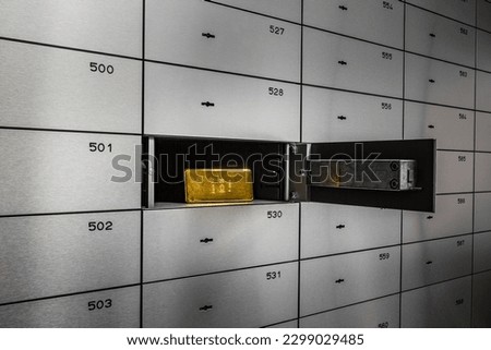 Bar of gold in safe deposit box. Royalty-Free Stock Photo #2299029485