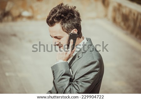 portrait man in suit talking sell phone