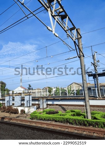 Cables in train station with electric power engine boxes with blue sky in Depok Baru station, Indonesia Royalty-Free Stock Photo #2299052519