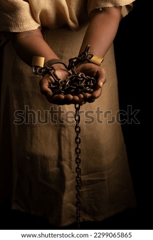 Portrait of a black woman in chains and with an iron mask on her face holding chains. Slave Anastacia. Slavery in Brazil. Royalty-Free Stock Photo #2299065865