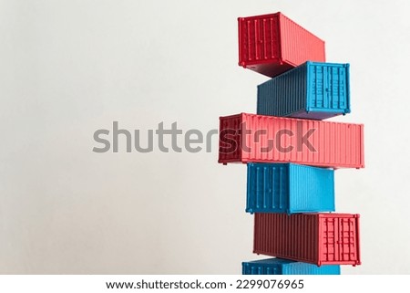Blue and red containers model stacked with white wall background copy space. Concept of GDP global world economy, import export industrial, goods production, manufacturing, cargo shipping logistics. Royalty-Free Stock Photo #2299076965